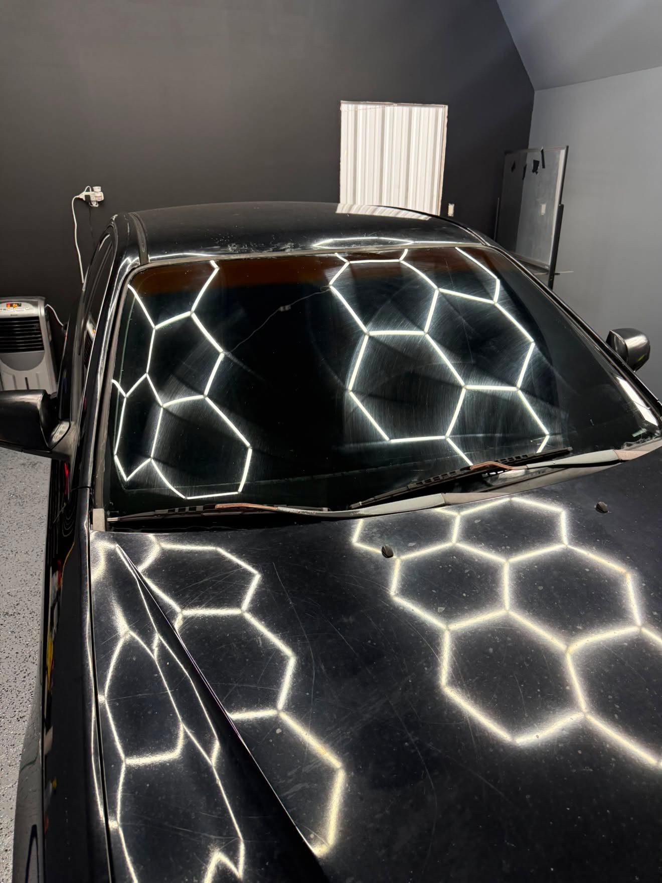 Black car windshield with hexagon lighting