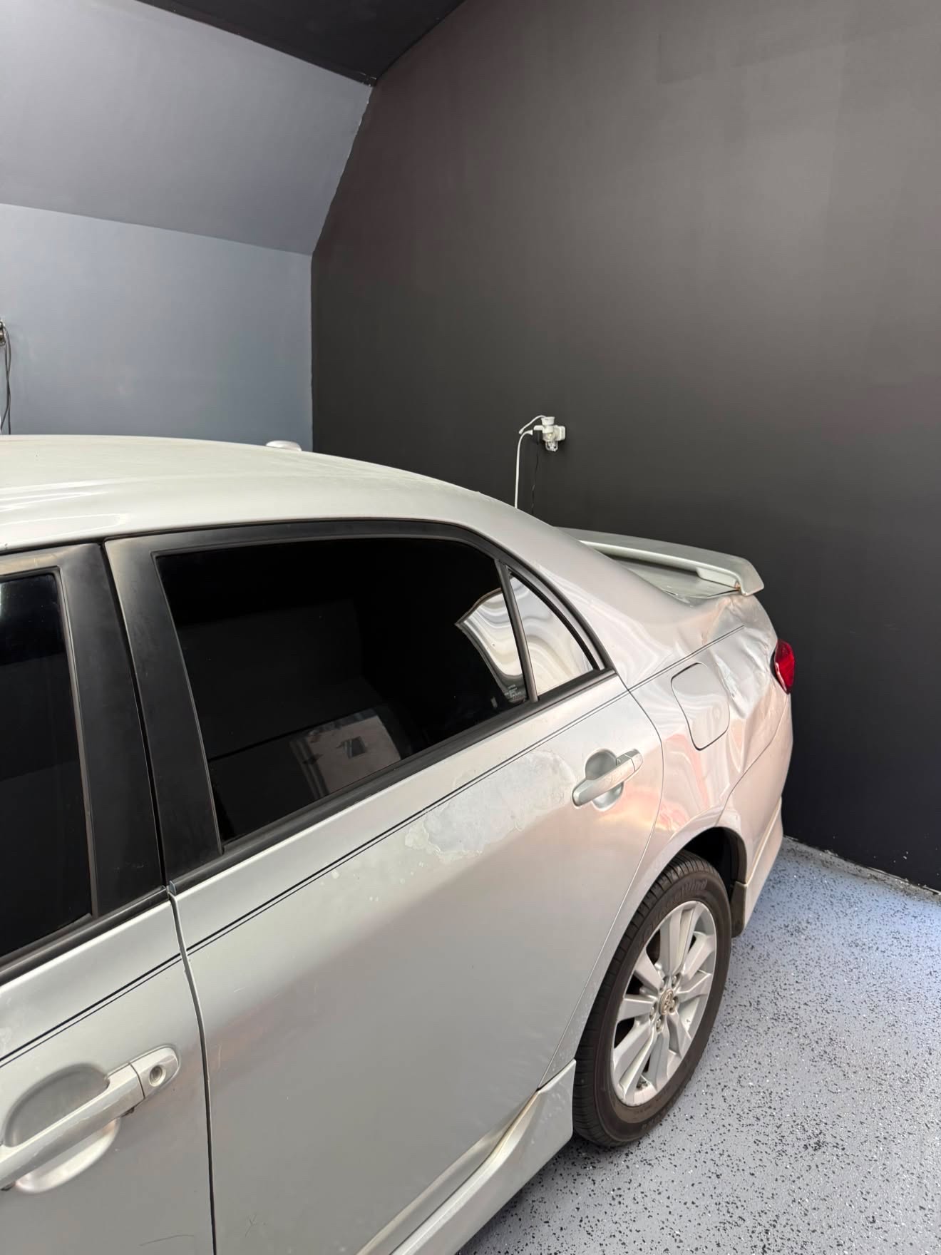 Silver Toyota Corolla with dark rear tint