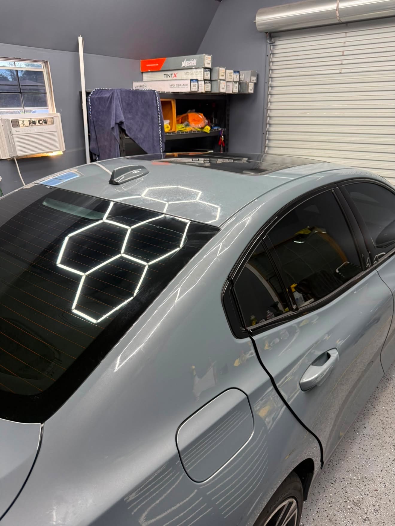 Blue-gray BMW with hexagon reflection